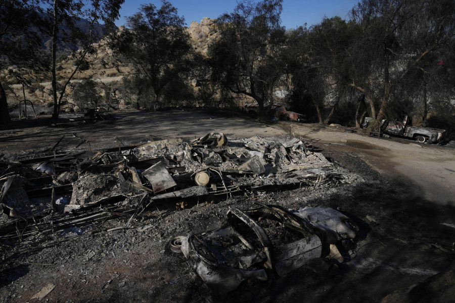 Burned vehicles and a mobile home are left charred by the Highland Fire on Luis Quinonez' property, Tuesday, Oct. 31, 2023, in Aguanga, Calif.