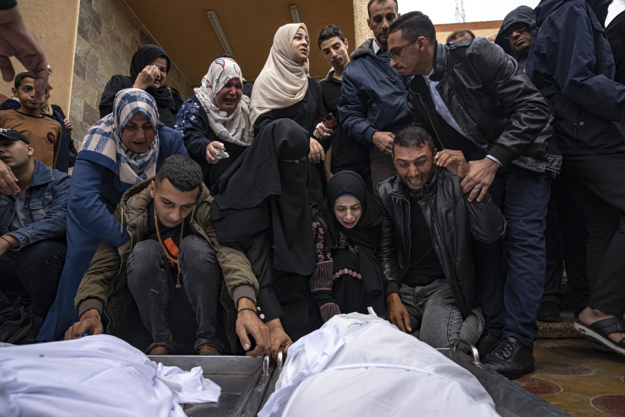 Palestinians mourn their relatives killed in the Israeli bombardment of the Gaza Strip, at the hospital in Khan Younis, Wednesday, Nov. 15, 2023.