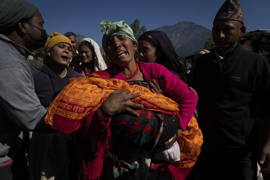 A woman holds the lifeless body of her grand child killed in earthquake in Jajarkot district, northwestern Nepal, Sunday, Nov. 5, 2023. Friday night's earthquake in the district killed more than hundred people while more than fifty were killed in the neighboring Rukum district, officials said.