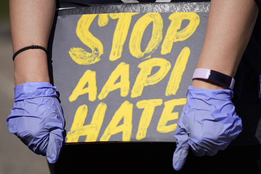 A person holds a sign and attends a rally to support stop AAPI (Asian Americans and Pacific Islanders) hate at the Logan Square Monument in Chicago, on March 20, 2021. (Nam Y.