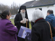 Bishop Alexei, the head of the Orthodox Church in Alaska, is shown Oct. 13, 2023, speaking to others gathered at a ceremony marking the beginning of a restoration project at the old St. Nicholas Church in Eklutna, Alaska. The Orthodox church is the oldest standing building in the Municipality of Anchorage.