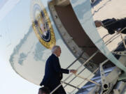 President Joe Biden boards Air Force One at Dobbins Air Reserve Base in Marietta, Ga., Tuesday, Nov. 28, 2023, to travel to Denver after attending a tribute service for former first lady Rosalynn Carter in Atlanta.