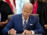 FILE - President Joe Biden signs a presidential memorandum in the Oval Office of the White House, Nov. 13, 2023, in Washington. Biden has announced five nominees to federal judgeships, including the first Muslim-American on any circuit court. The Democratic president is looking to add to more than 150 of his judicial selections that have already been confirmed to the bench.
