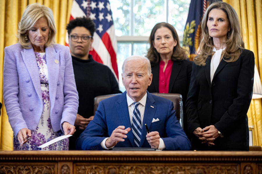 President Joe Biden, accompanied by from left, first lady Jill Biden, Office of Management and Budget director Shalanda Young, White House Gender Policy Council director Jen Klein, and Women&rsquo;s Alzheimer&rsquo;s Movement founder Maria Shriver, responds to a question from a reporter after signing a presidential memorandum that will establish the first-ever White House Initiative on Women&rsquo;s Health Research in the Oval Office of the White House, Monday, Nov. 13, 2023, in Washington.