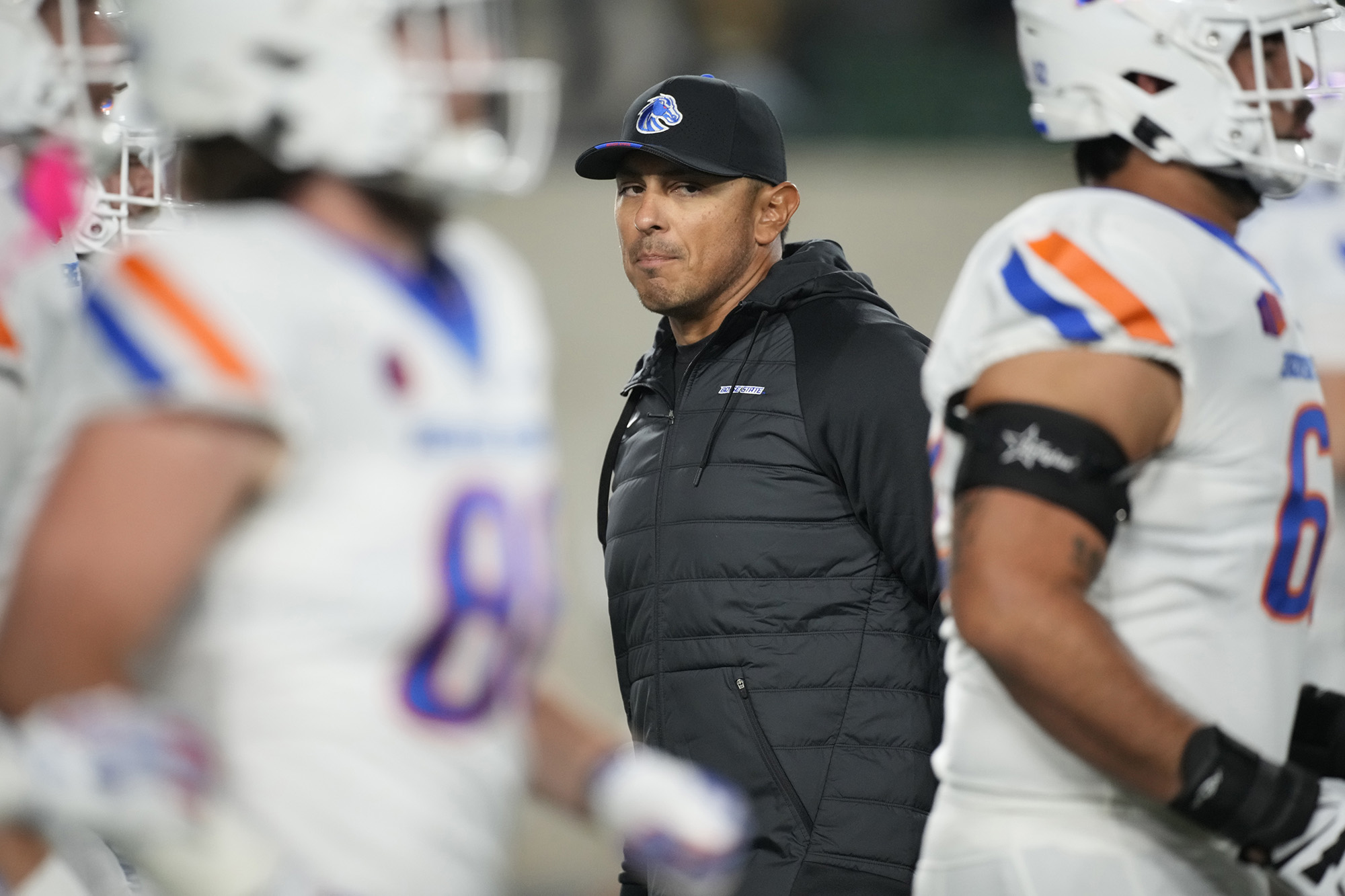 Boise State head coach Andy Avalos looks on as players warm up before an NCAA college football game against Colorado State on Saturday, Oct. 14, 2023, in Fort Collins, Colo.