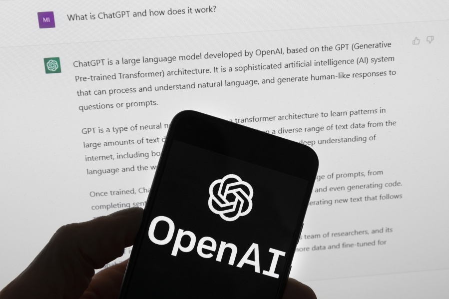 FILE - The OpenAI logo is seen on a mobile phone in front of a computer screen which displays output from ChatGPT, Tuesday, March 21, 2023, in Boston. British Prime Minister Rishi Sunak will host a two-day summit focused on frontier AI. It's reportedly expected to be draw a group of about 100 officials from 28 countries, including U.S. Vice President Kamala Harris and executives from key U.S. artificial intelligence companies including OpenAI, Google's DeepMind and Anthropic.