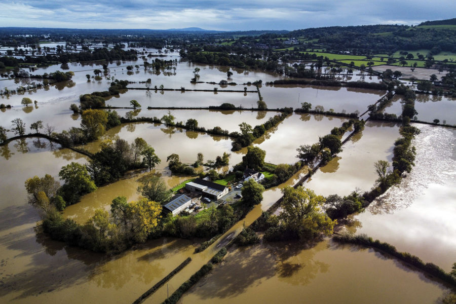 Flooded fields are seen in Powys in Wales, Sunday, Oct. 22, 2023. A fourth person has died in Britain during a storm that pounded the U.K. and northern Europe with gale-force winds and torrential rain.