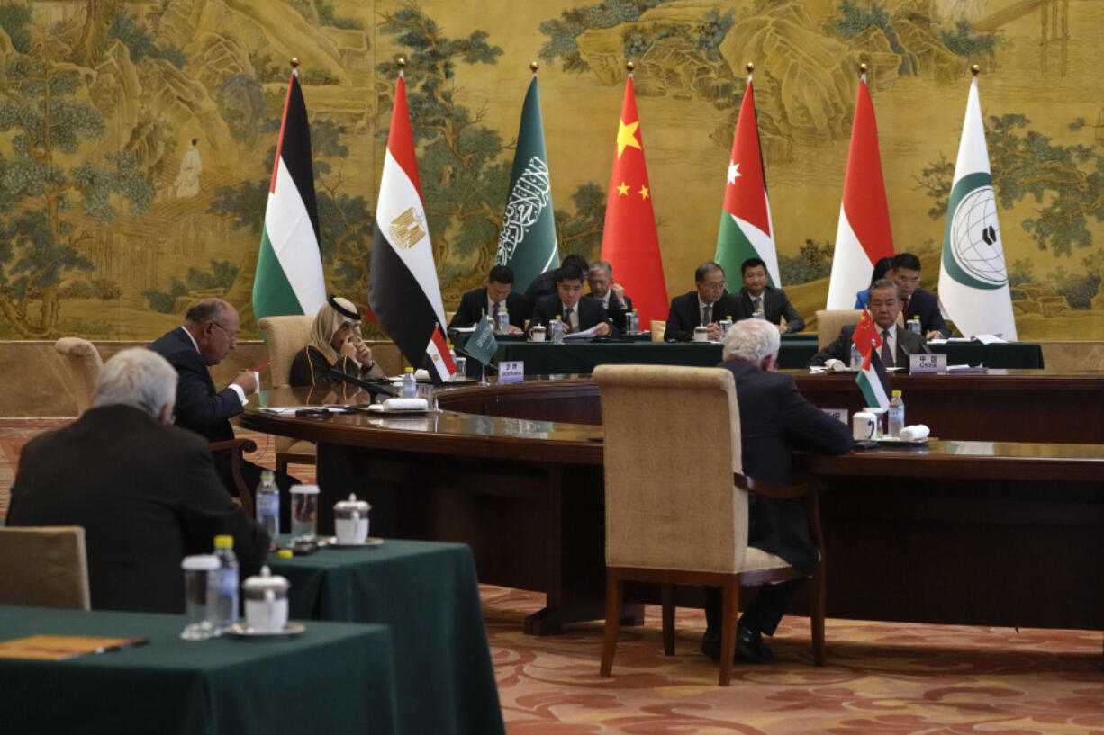 Chinese Foreign Minister Wang Yi, far right, Saudi Arabia&rsquo;s Foreign Minister Prince Faisal bin Farhan Al Saud, third left, and Egyptian Foreign Minister Sameh Shoukry, second left, listen to a speech by Palestinian Foreign Minister Riyad al-Maliki, foreground center, during a round table meeting at the Diaoyutai state guesthouse in Beijing, Monday, Nov. 20, 2023. Wang welcomed five Arab and Islamic counterparts to Beijing on Monday, saying his country would work with &ldquo;our brothers and sisters&rdquo; in the Arab and Islamic world to try to end the fighting in Gaza as soon as possible.
