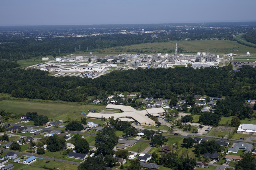 FILE - The Fifth Ward Elementary School and residential neighborhoods sit near the Denka Performance Elastomer Plant, back, in Reserve, La., Sept. 23, 2022. The Environmental Protection Agency spent more than a year investigating whether Louisiana's oversight of industrial air emissions discriminated against Black residents. The EPA's investigation ended, however, before it secured commitments from the state to strengthen its oversight.
