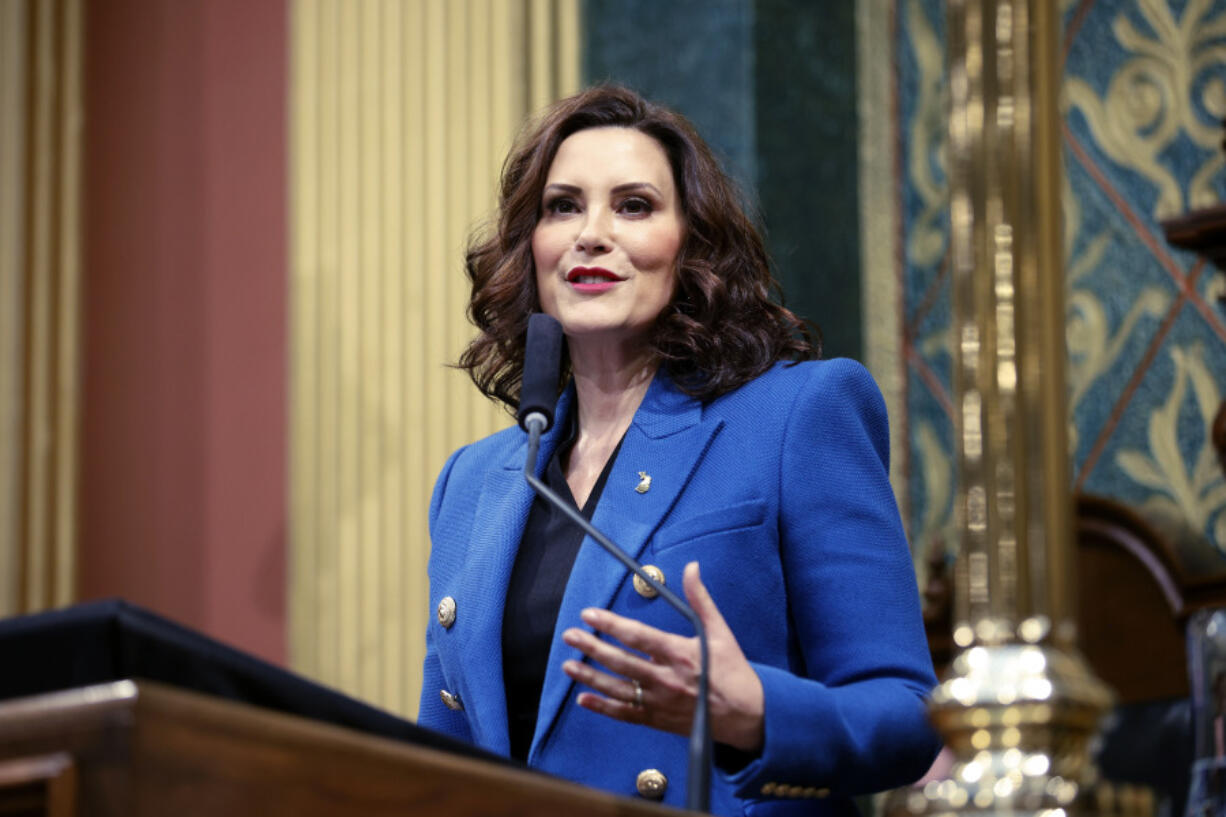 FILE - Michigan Gov. Gretchen Whitmer delivers her State of the State address to a joint session of the House and Senate, Jan. 25, 2023, at the state Capitol in Lansing, Mich. Michigan will join four other states in requiring utility providers to transition to 100% carbon-free energy generation by 2040 under legislation that will soon be signed by Whitmer.