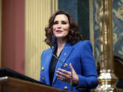 FILE - Michigan Gov. Gretchen Whitmer delivers her State of the State address to a joint session of the House and Senate, Jan. 25, 2023, at the state Capitol in Lansing, Mich. Michigan will join four other states in requiring utility providers to transition to 100% carbon-free energy generation by 2040 under legislation that will soon be signed by Whitmer.