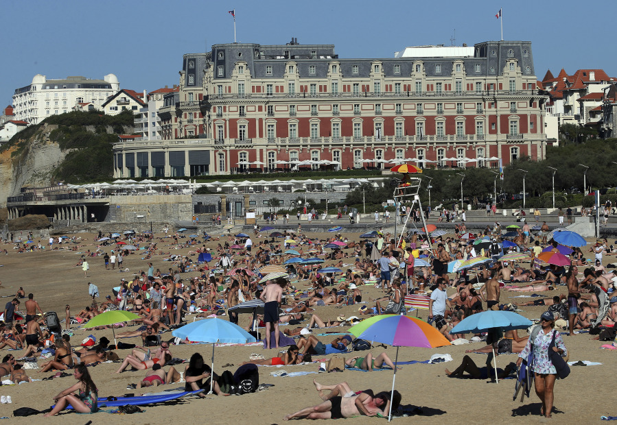 FILE - People sunbathe on Biarritz&rsquo; beach, southwestern France, Oct. 7, 2023. October was the fifth straight month that Earth set a record for the hottest month in recorded history.