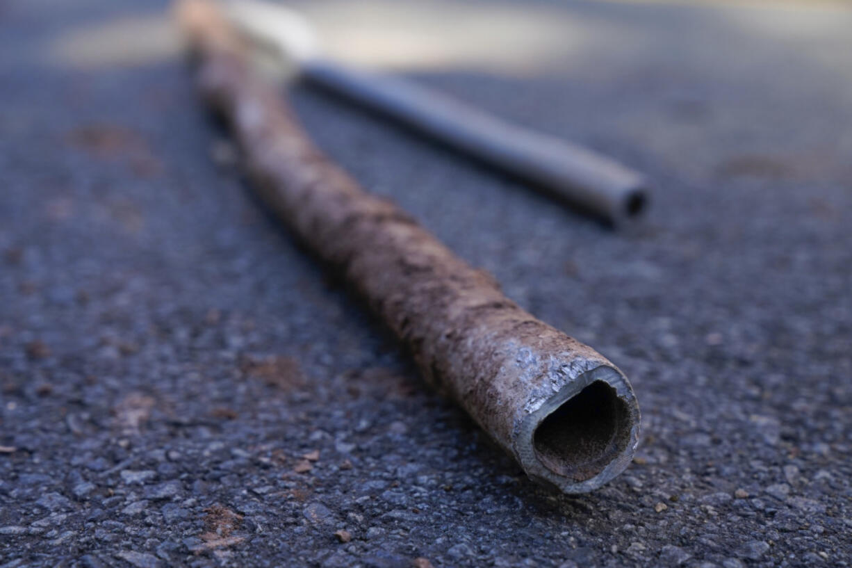 FILE - Lead water pipes pulled from underneath the street are seen in Newark, N.J., Oct. 21, 2021.