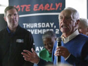 Former Kentucky Governor Steve Beshear, right, introduces his son, and Democratic Gubernatorial candidate for re-election Andy Beshear during a stop of his statewide bus tour in Richmond, Ky., Monday, Oct. 30, 2023. (AP Photo/Timothy D.
