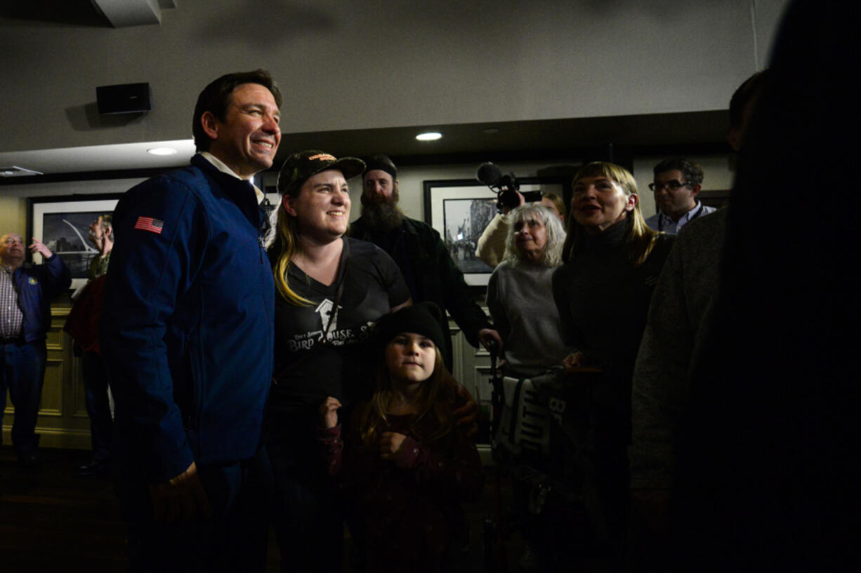 Republican presidential candidate Ron DeSantis poses for photos with people during a Town Hall event at Tempesta&rsquo;s in Keene, N.H., on Nov. 21, 2023.