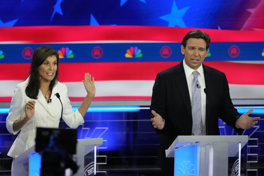 Republican presidential candidates former U.N. Ambassador Nikki Haley and Florida Gov. Ron DeSantis talk during a Republican presidential primary debate hosted by NBC News, Wednesday, Nov. 8, 2023, at the Adrienne Arsht Center for the Performing Arts of Miami-Dade County in Miami.