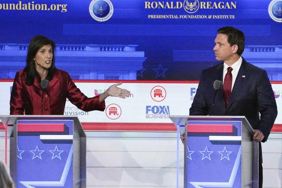 FILE - Republican presidential candidate and former U.N. Ambassador Nikki Haley, left, with Florida Gov. Ron DeSantis, speaks during a Republican presidential primary debate hosted by FOX Business Network and Univision, Sept. 27, 2023, at the Ronald Reagan Presidential Library in Simi Valley, Calif. Haley has been rising with donors and voters thanks in part to strong debate performances and the campaign's increased focus on foreign policy. That's come partly at the expense of Florida Gov. Ron DeSantis. But donors and voters seeking an alternative to former President Donald Trump haven't fully coalesced around Haley. (AP Photo/Mark J.