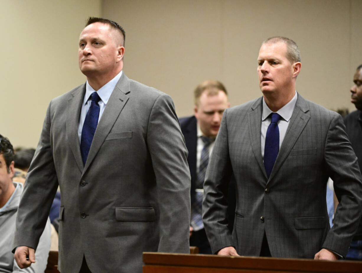 FILE - Paramedics Jeremy Cooper, left, and Peter Cichuniec, right, attend an arraignment at the Adams County Justice Center in Brighton, Colo., on Jan. 20, 2023. Opening statements are scheduled Wednesday, Nov. 29,  in the third and final trial over the 2019 death of Elijah McClain, who died after he was stopped by police in suburban Denver. Jurors will have to decide if the two paramedics committed a crime when they gave the 23-year-old Black man an overdose of the sedative ketamine after he was forcibly restrained by officers in Aurora.