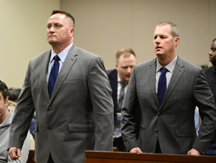 FILE - Paramedics Jeremy Cooper, left, and Peter Cichuniec, right, attend an arraignment at the Adams County Justice Center in Brighton, Colo., on Jan. 20, 2023. Opening statements are scheduled Wednesday, Nov. 29,  in the third and final trial over the 2019 death of Elijah McClain, who died after he was stopped by police in suburban Denver. Jurors will have to decide if the two paramedics committed a crime when they gave the 23-year-old Black man an overdose of the sedative ketamine after he was forcibly restrained by officers in Aurora.