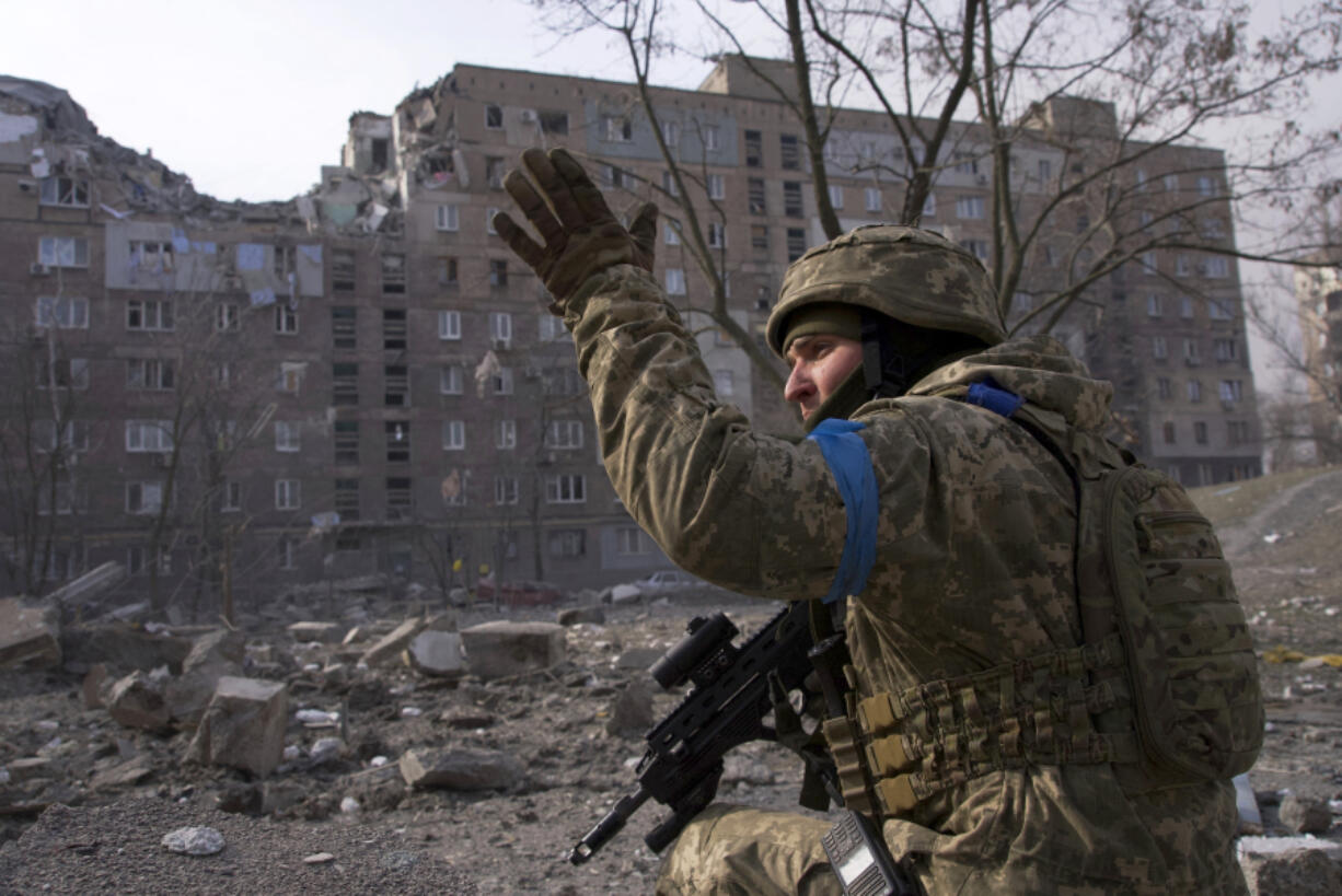 FILE - A Ukrainian serviceman guards his position in Mariupol, Ukraine, March 12, 2022.