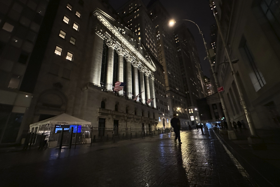 A person walks past the New York Stock Exchange on Tuesday, Nov. 21, 2023 in New York.