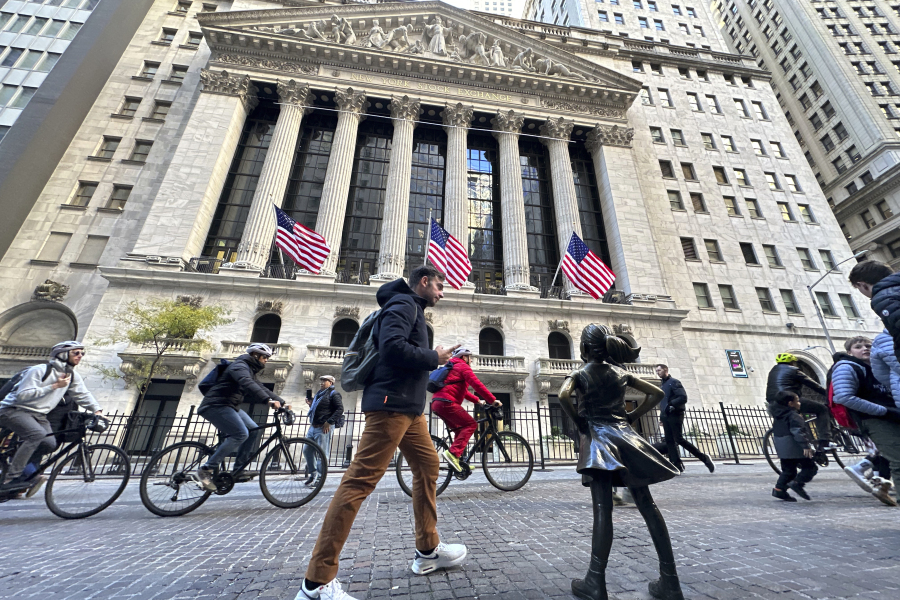 A man passes the &ldquo;Fearless Girl&rdquo; statue in front of the New York Stock Exchange in New York on Friday, November 3, 2023. Shares opened lower in Europe after a mixed day in Asia on Tuesday as investors waited for updates on inflation and how American consumers are feeling about the economy.