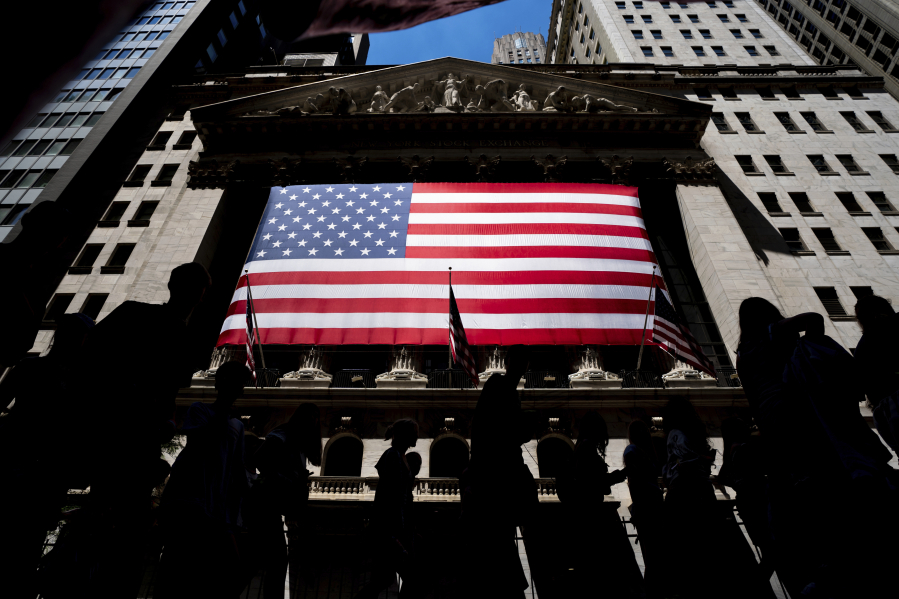 FILE - People walk past the New York Stock Exchange on Wednesday, June 29, 2022 in New York. Wall Street pointed higher before the open Friday, Nov. 17, 2023, as most major markets looked set to end the week with solid gains.