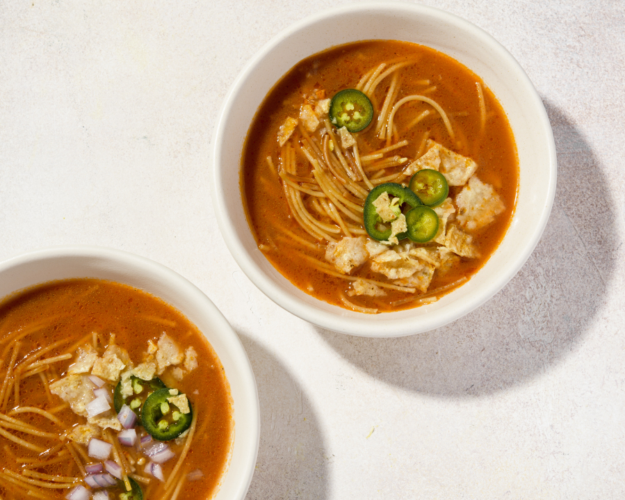 This image released by Milk Street shows a recipe for Mexican noodle soup with fire-roasted tomatoes.