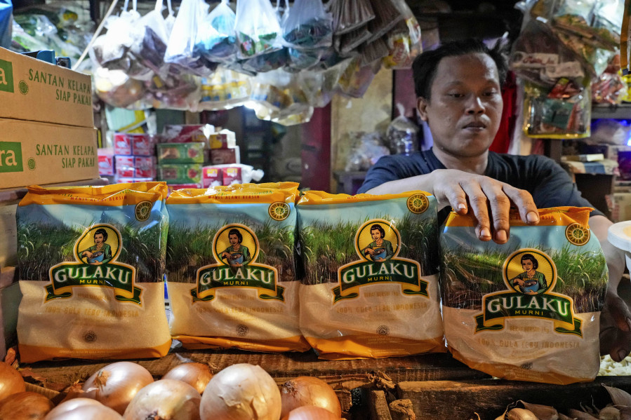 A vendor arranges packages of sugar at a market Oct. 24 in Jakarta, Indonesia. Indonesia &mdash; the biggest sugar importer last year, according to the United States Department of Agriculture &mdash; has cut back on imports.