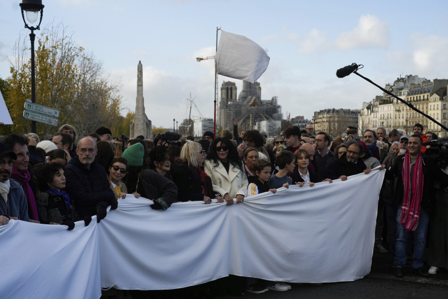 People take part to a silent march for peace between Israelis and Palestinians, in Paris, Sunday, Nov. 19, 2023. Hundreds of French performers from different cultural and religious backgrounds called for a silent march Sunday in central Paris to call for peace between Israelis and Palestinians and unity among French people.