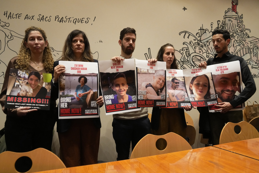 From the left, Adva Gutman, Ayelet Sela bin Nun, Alon Adar, Adva Adar and Daniel Toledano, hold portraits of relatives held hostages by the Hamas militants during a press conference at the Paris town hall, Tuesday, Oct. 31, 2023 in Paris. Families of Israelis taken hostage by Hamas militants on Oct. 7 demand their release and ask for support from the international community. Israel says 240 people were taken by Hamas during the attack.