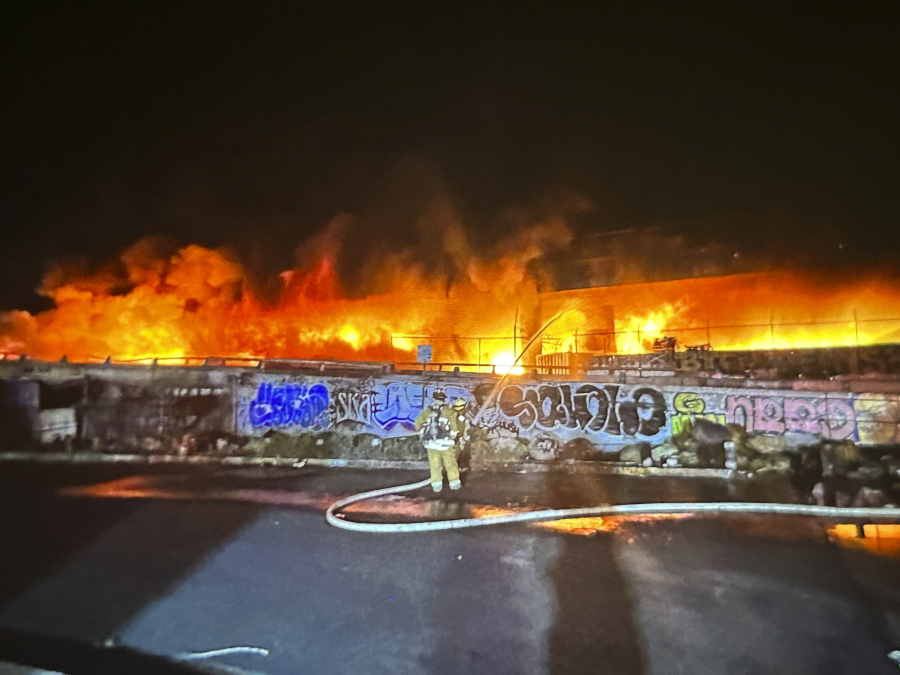 This photo provided by the California Department of Transportation shows an early morning fire along Interstate 10 near downtown Los Angeles, Saturday, Nov. 11, 2023.