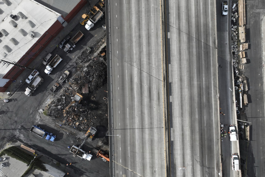 The site of a fire is seen under Interstate 10, Monday, Nov. 13, 2023, in Los Angeles. Los Angeles drivers are being tested in their first commute since a weekend fire that closed a major elevated interstate near downtown. (AP Photo/Jae C.