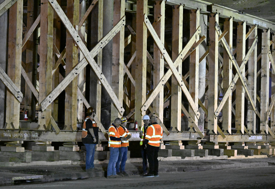 Construction workers gather at the repairs to the I-10 freeway, which was closed by an underpass fire on Saturday, Nov. 11, 2023, in Los Angeles, Sunday, Nov. 19.
