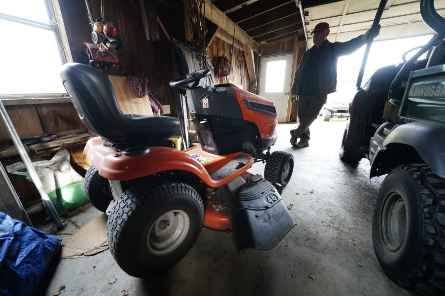 Trailer park owner Ed Smith looks at one of Geoffrey Holt&rsquo;s riding mowers at Stearns Park, Wednesday, Nov. 15, 2023, in Hinsdale, N.H. (AP Photo/Robert F.