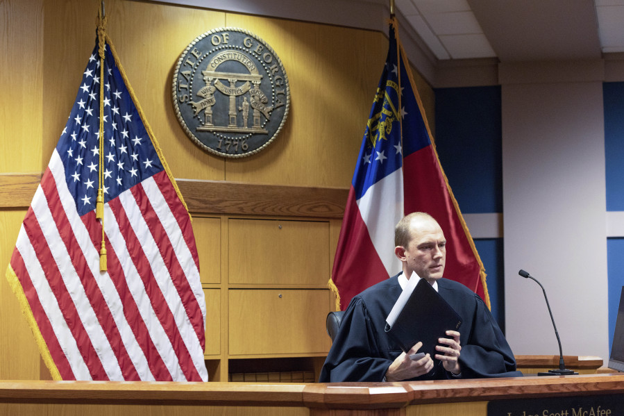 Fulton County Superior Court Judge Scott McAfee presides over a hearing related to the Georgia election indictments, Wednesday, Nov. 15, 2023,  at Fulton County Courthouse in Atlanta. Jonathan Miller, an attorney for Misty Hampton, a former elections director charged alongside former President Donald Trump and others over efforts to overturn Georgia&rsquo;s 2020 election said Wednesday that he released videos of prosecutors&rsquo; interviews with some of their codefendants because he thought they helped his client and the public had the right to see them. Prosecutors initially asked the judge to impose an order to prevent the release of any evidence in the case.