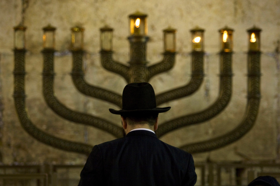 An Ultra-Orthodox Jewish man stands in front of a menorah on the third eve of Hanukkah, at the Western Wall, Judaism&rsquo;s holiest site in Jerusalem&rsquo;s old city, in 2009.