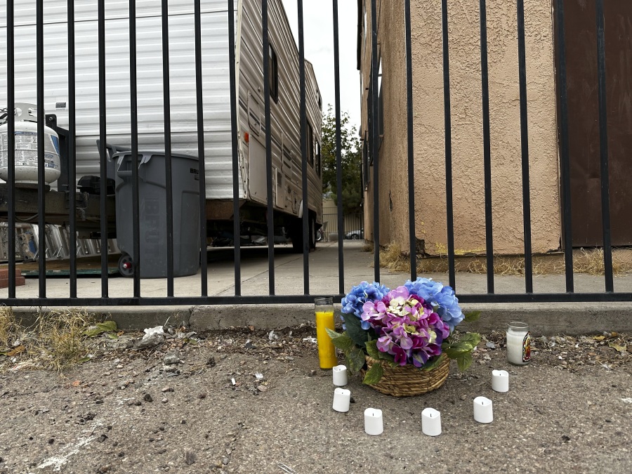 A small memorial is placed in an alleyway near Rancho High School in eastern Las Vegas on Wednesday, Nov. 15, 2023, the day after authorities announced the arrests of eight students on suspicion of murder in the beating of a classmate. Police said the fight happened two weeks earlier after classes ended for the day and left a 17-year-old boy dead.