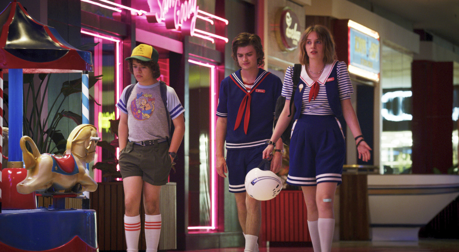 This image released by Netflix shows, from left, Gaten Matarazzo, Joe Keery, and Maya Hawke in a scene from "Stranger Things." The scene was shot on location at the Gwinnett Place Mall in Duluth, Ga.