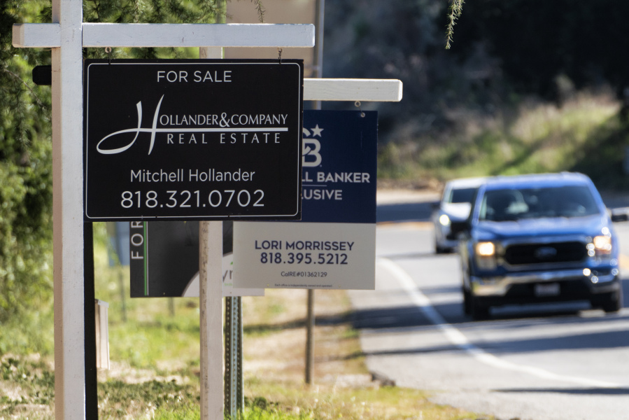 File - Home sale signs are posted along Topanga Canyon road in Los Angeles on Oct. 19, 2023. On Tuesday, the National Association of Realtors on reports on existing home sales for October.