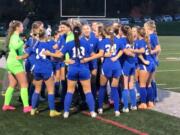 The Ridgefield girls soccer team huddles before a Class 2A state playoff match against Sequim on Wednesday, Nov. 8, 2023 at Ridgefield High School.