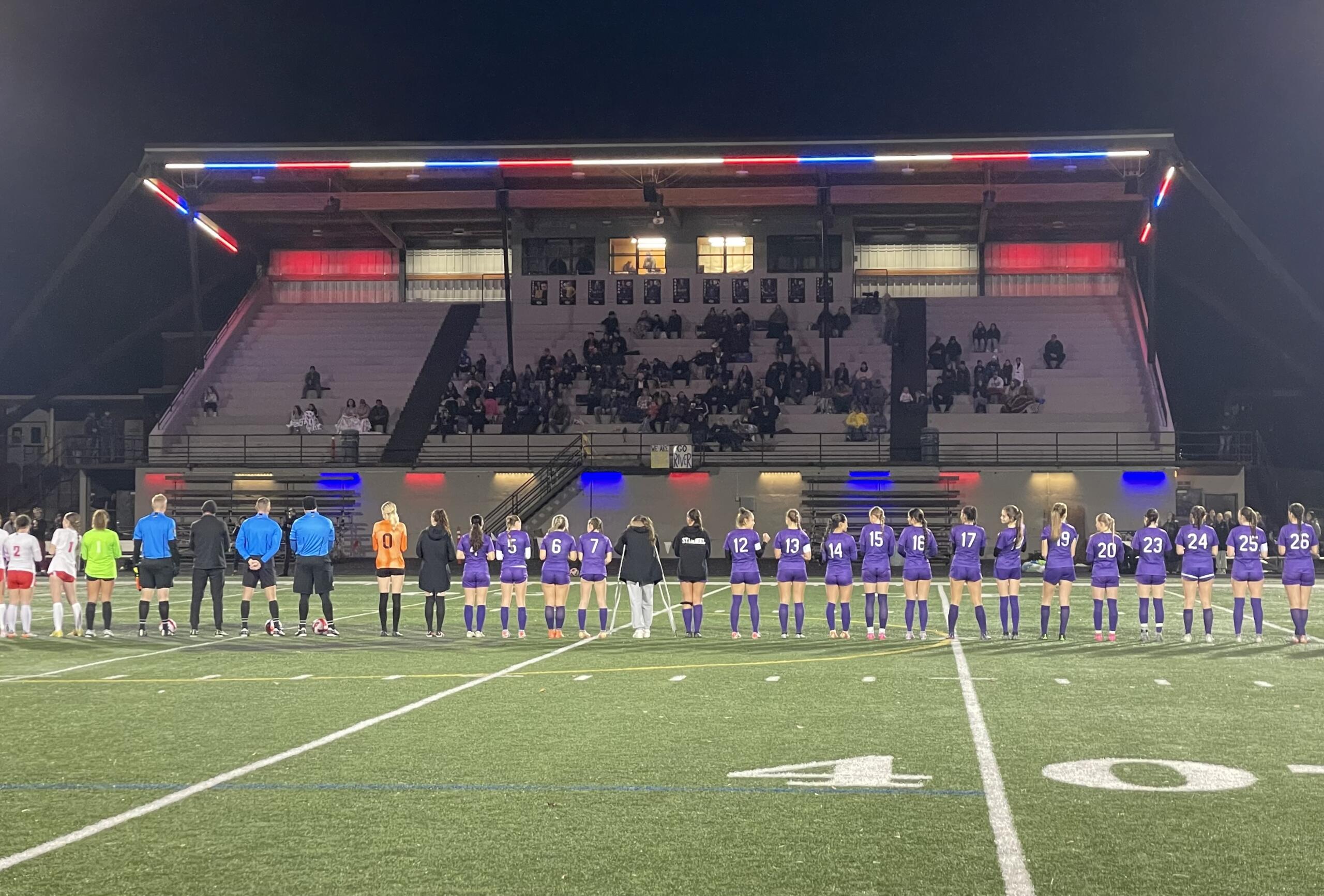 Columbia River and Steilacoom players gather on the field for introductions prior to their Class 2A girls soccer state playoff game on Wednesday, Nov. 8, 2023, at Columbia River High School.
