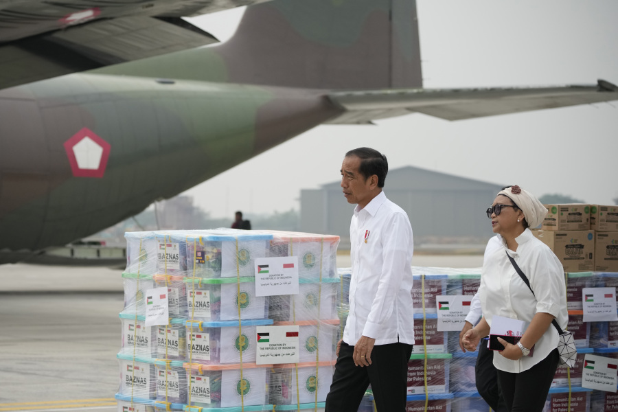 Indonesian President Joko Widodo, left, and Foreign Minister Retno Marsudi inspect the relief supplies for Palestinians in Gaza, before its departure at Halim Perdanakusuma air base in Jakarta, Indonesia, Saturday, Nov. 4, 2023.