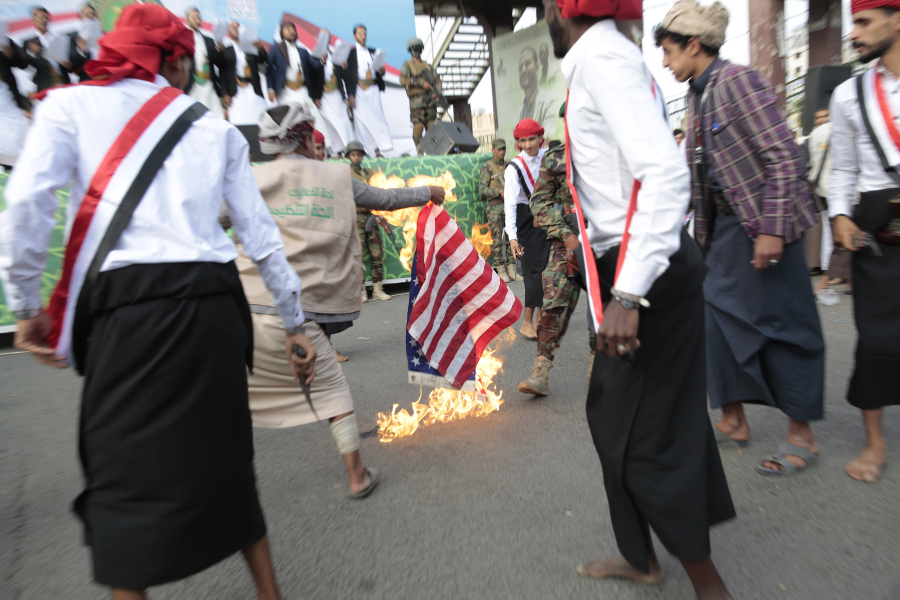FILE - Houthi supporters burn a representation of the U.S. flag during a rally to mark the seventh anniversary of the Houthis&rsquo; takeover of the Yemeni capital, in Sanaa, Yemen, Tuesday, Sept. 21, 2021. For years, the Houthi rebels controlling northern Yemen have chanted slogans at their mass rallies calling for the destruction of Israel. But they never joined any conflict beyond the confines of their own country&rsquo;s civil war or nearby in the Arabian Peninsula. The Iranian-backed Shiite Muslim force has launched at least six drone and missile attacks toward southern Israel since the Israel-Hamas war began on Oct. 7.