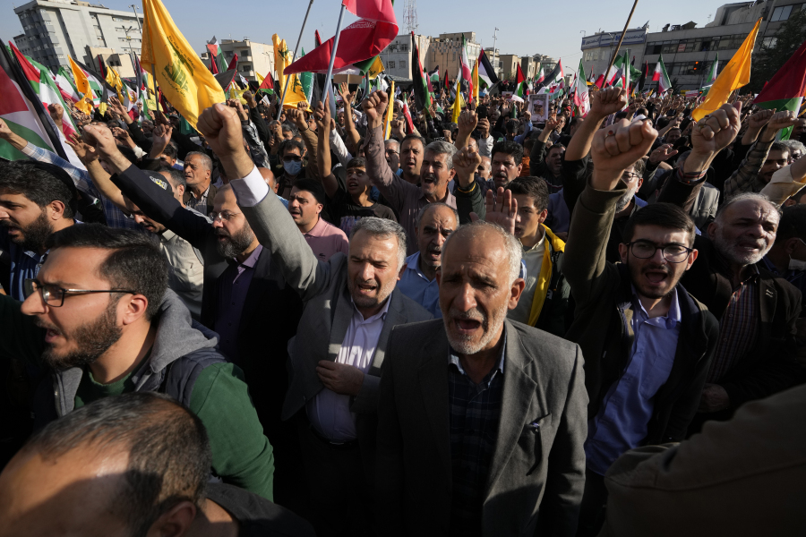 Iranian protesters chant slogans as they wave their national flags and Lebanon's militant Hezbollah group and Palestinian flags in an anti-Israel rally at Enqelab-e-Eslami (Islamic Revolution) Sq. in Tehran, Iran, on Oct. 18.