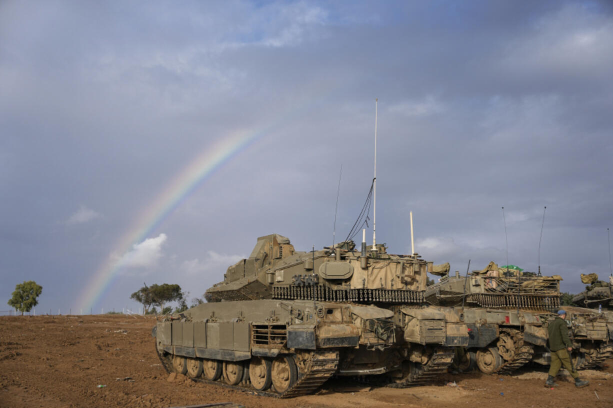 Israeli tanks parked at an army staging area near Israel&rsquo;s border with Gaza, southern Israel, Monday, Nov. 27, 2023. on the fourth day of a temporary cease-fire between Israel and Hamas.