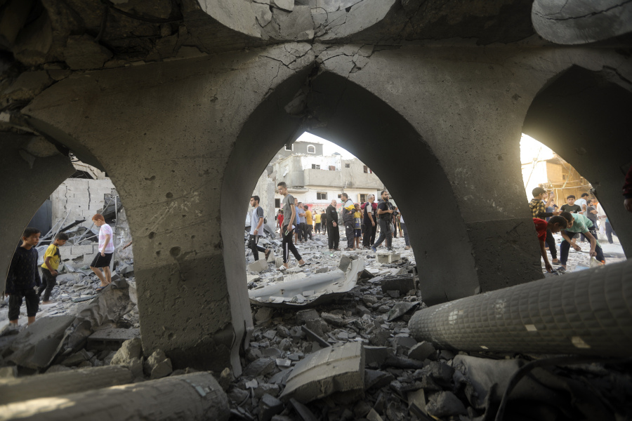 Palestinians inspect the damage of a destroyed mosque following an Israeli airstrike in Khan Younis refugee camp, southern Gaza Strip, Wednesday, Nov. 8, 2023.
