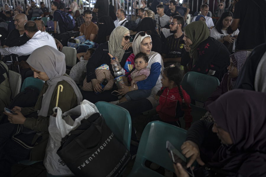 Palestinians wait to cross into Egypt at Rafah, Gaza Strip, on Wednesday, Nov. 1, 2023.