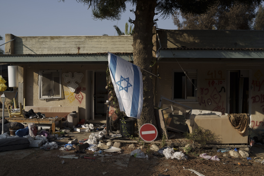 FILE - An Israeli flag hangs between destroyed houses in the kibbutz Kfar Azza, Israel, near the Gaza Strip, Monday, Nov. 13, 2023. It has become an Israeli mantra throughout the latest war in Gaza: Hamas is ISIS. Since the bloody Hamas attack on Oct. 7 that triggered the war, Israeli leaders and commanders have likened the Palestinian militant group to the Islamic State group. They point to Hamas&rsquo; brutal slaughter of hundreds of civilians and compare their Gaza war to the U.S.-led campaign to defeat IS in Iraq and Syria.