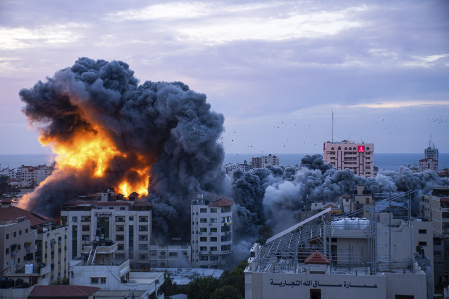 FILE - Fire and smoke rises following an Israeli airstrike, in Gaza City, Saturday, Oct. 7, 2023. Six weeks of fighting since then has seen hundreds of thousands of Palestinians flee to southern Gaza, where they cram into shelters and take refuge with friends and family.